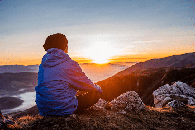 peaceful-man-sitting-mountain-top-sunrise-with-nature-landscape-healthy-lifestyle_606562-1039